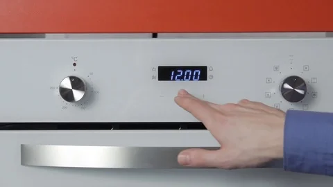 Metallic Toggle Switch of the Cooker Oven. Close-up View. Digital Clock of oven. Stock Footage 84831903