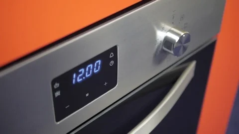 Metallic Toggle Switch of the Cooker Oven. Close-up View. Digital Clock of oven. Stock Footage 84831918