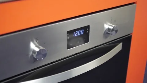 Metallic Toggle Switch of the Cooker Oven. Close-up View. Digital Clock of oven. Stock Footage 84831928