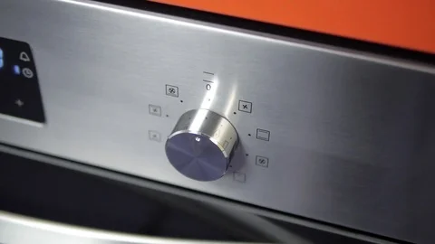 Metallic Toggle Switch of the Cooker Oven. Close-up View. Digital Clock of oven. Stock Footage 84831935