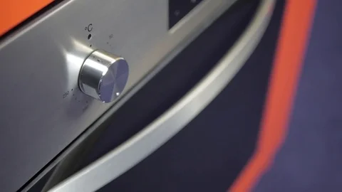 Metallic Toggle Switch of the Cooker Oven. Close-up View. Digital Clock of oven. Stock Footage 84831940