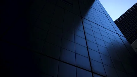 Metallic wall of a building shines dark blue. Moving camera. Stock Footage 220110362