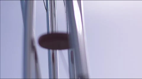 Metallic wind chimes gently swaying Stock Footage 336235400