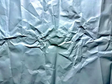 Metallic wrinkled texture displays complex intricate creases and deep folds f Stock Photos