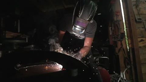 Metalsmith Welding in Shed Stock Footage 243204336