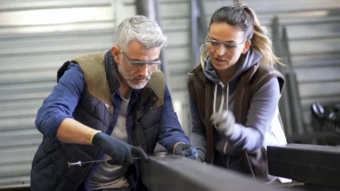 Metalworker with apprentice in workshop Stock-Footage 103287429