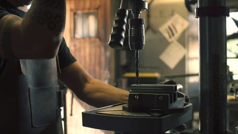 Metalworker drilling metal in the workshop Stock Footage 128597394