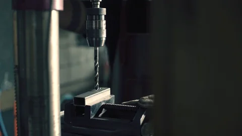 Metalworker drilling metal in the workshop Stock Footage 128597506