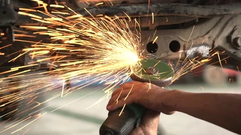 Metalworker grinding in auto body repair shop, closeup Stock Footage
