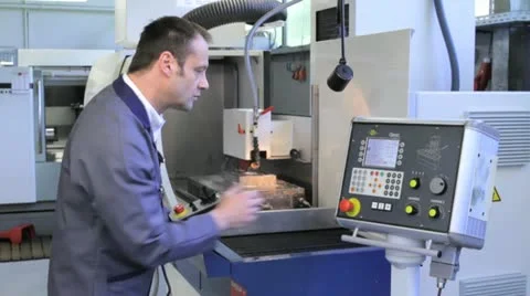 Metalworker operates CNC machine - 1 Stock Footage 11899931