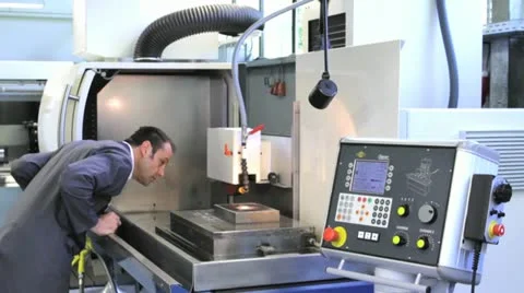 Metalworker operates CNC machine - 3 Stock Footage 11899938