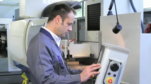 Metalworker operates CNC machine - 4 Stock Footage 11899839