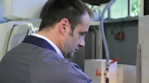 Metalworker operates CNC machine - closeup panel - 1 Stock Footage 11899848