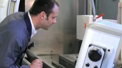 Metalworker operates CNC machine - closeup - 5 Stock Footage 11899872