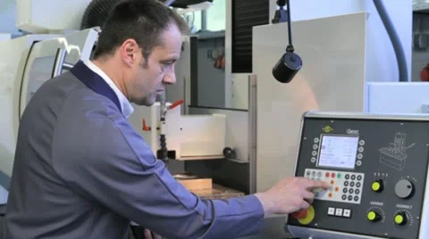 Metalworker operates CNC machine - hand on panel - 1 Video stock 11899929