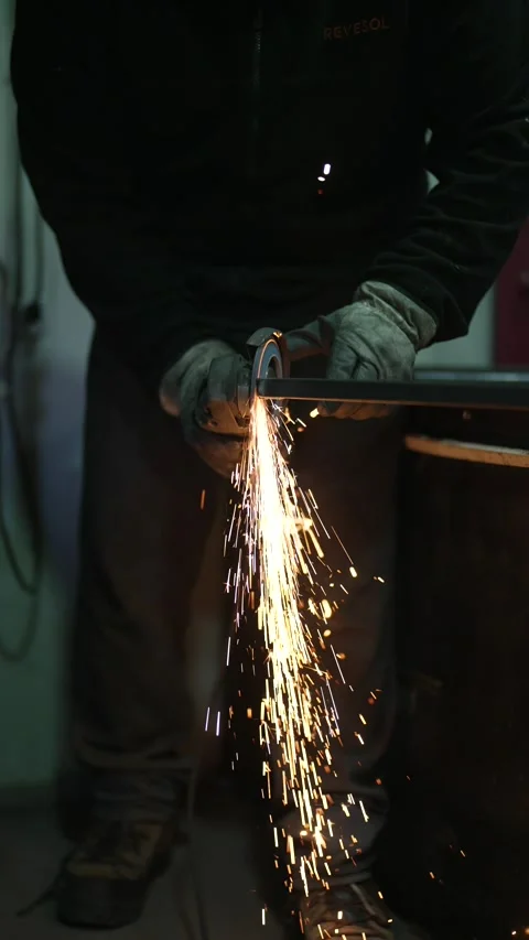 Metalworker using grinder tool with sparks flying during fabrication Stock Footage 308827844