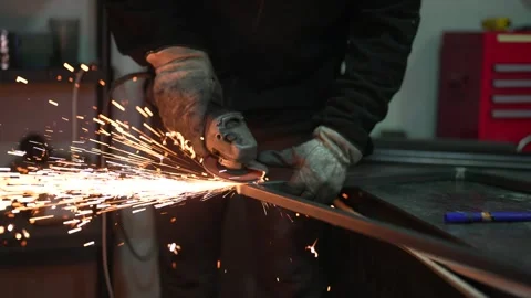 Metalworker using grinder tool with sparks flying during fabrication Stock Footage 308828233