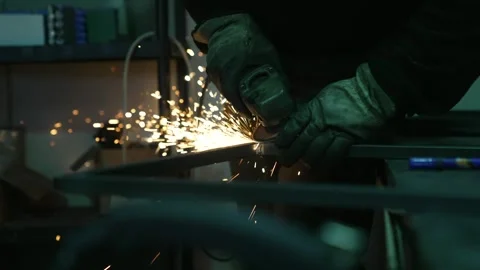 Metalworker using grinder tool with sparks flying during fabrication Stock Footage 308828907