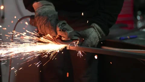 Metalworker using grinder tool with sparks flying during fabrication Stock Footage 308829180