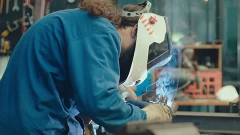 Metalworker Welding Pipe and Hitting It with Hammer Stock Footage 255751451