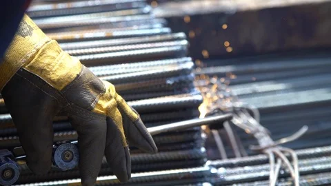 Metalworker worker processes metal rods with welding machine closeup Stock Footage 113452877