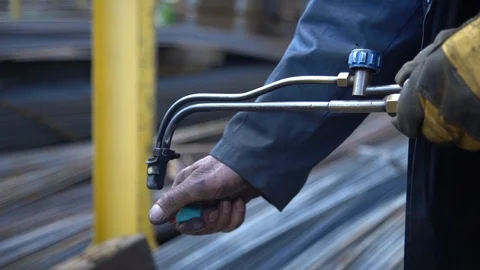Metalworker worker sets fire to a gas welding machine for cutting metal Stock Footage 113452807