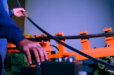 Metalworker is working with a bending machine Foto stock