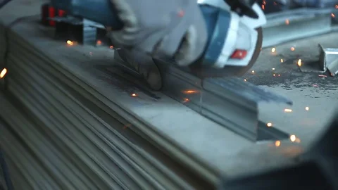 Metalworking with a hand-held circular saw, close up, the disk is blurred in Stockbeeldmateriaal 128496692