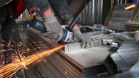 Metalworking with a hand-held circular saw, close up, the disk is blurred in Stockbeeldmateriaal 128496782
