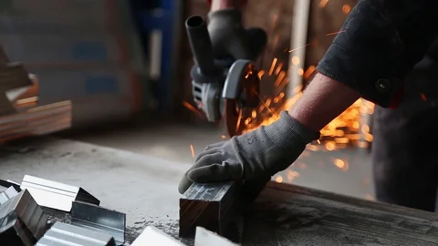 Metalworking with a hand-held circular saw, close up, the disk is blurred in Stockbeeldmateriaal 128496947