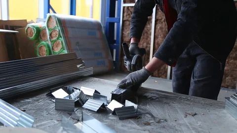 Metalworking with a hand-held circular saw, close up, the disk is blurred in Stockbeeldmateriaal 128496988