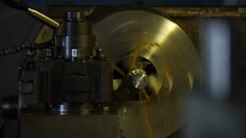 Metalworking lathe shaping component generating swarf in industrial workshop. Video stock 313815265