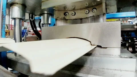 Metalworking. Special machine cuts metal sheets close up. Metal roof production Stock Footage 201185752