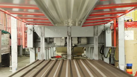 Metalworking. A special machine cuts the sheets of metal tiles. Close up. Metal Stock Footage 197383926