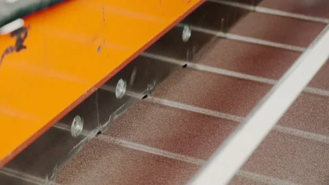 Metalworking. A special machine cuts the sheets of metal tiles. Close up. Metal Stock Footage 197384892