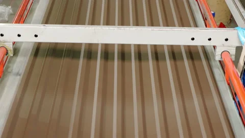 Metalworking. The special machine prepares sheets of a metal tile. The line of Stock Footage 197383816