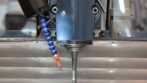 Metalworking. A vertically milling machine produces a boring hole in the Stock Footage 76023297