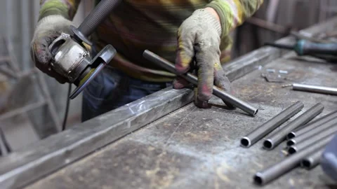 Metalworking workshop. The master grinds the metal with a grinding machine. Stock Footage 246178408