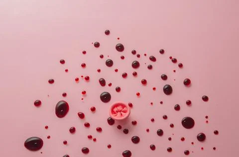 Metaphor of the anus on a pink background. Rectal bleeding, hemorrhoids. Stock Photos