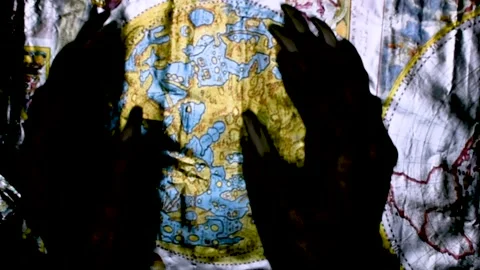 Metaphorical paws of the devil and ancient map of the world Stock Footage 229957982