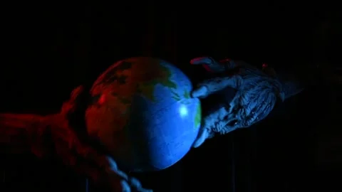 Metaphorical paws of the devil play with the planet Earth Video stock 221272083