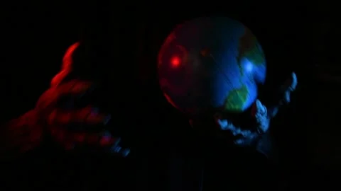 Metaphorical paws of the devil play with the planet Earth Stock Footage 221272093