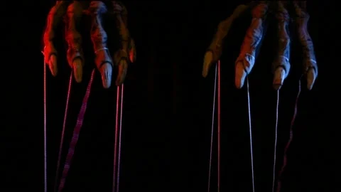 Metaphorical paws of the devil with threads for control Stock Footage 221271768