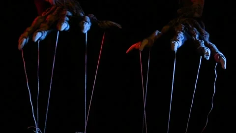 Metaphorical paws of the devil with threads for control Stock Footage 221271816