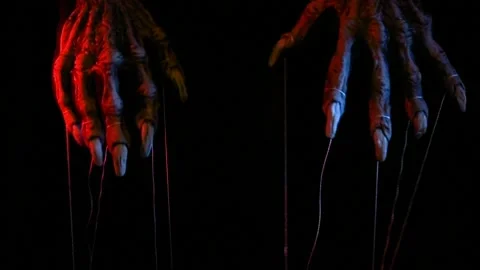 Metaphorical paws of the devil with threads for control Stock Footage 221272005