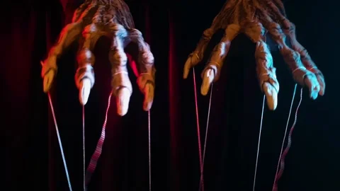 Metaphorical paws of the devil with threads for control Stock Footage 221272872