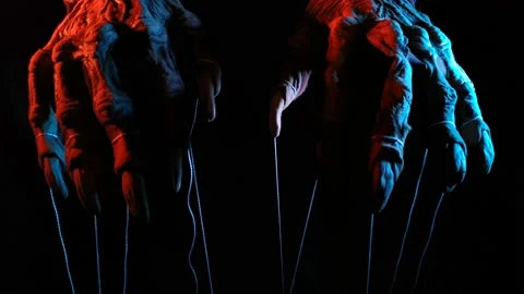 Metaphorical paws of the devil with threads for control Stock Footage 221272905