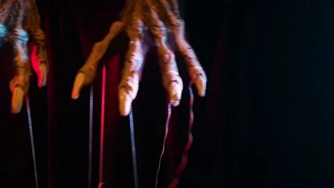 Metaphorical paws of the devil with threads for control Stock Footage 221272979