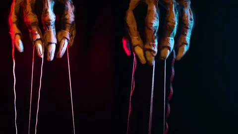 Metaphorical paws of the devil with threads for control Stock Footage 221273141