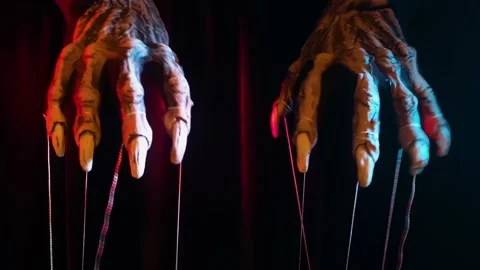 Metaphorical paws of the devil with threads for control Stock Footage 221273214